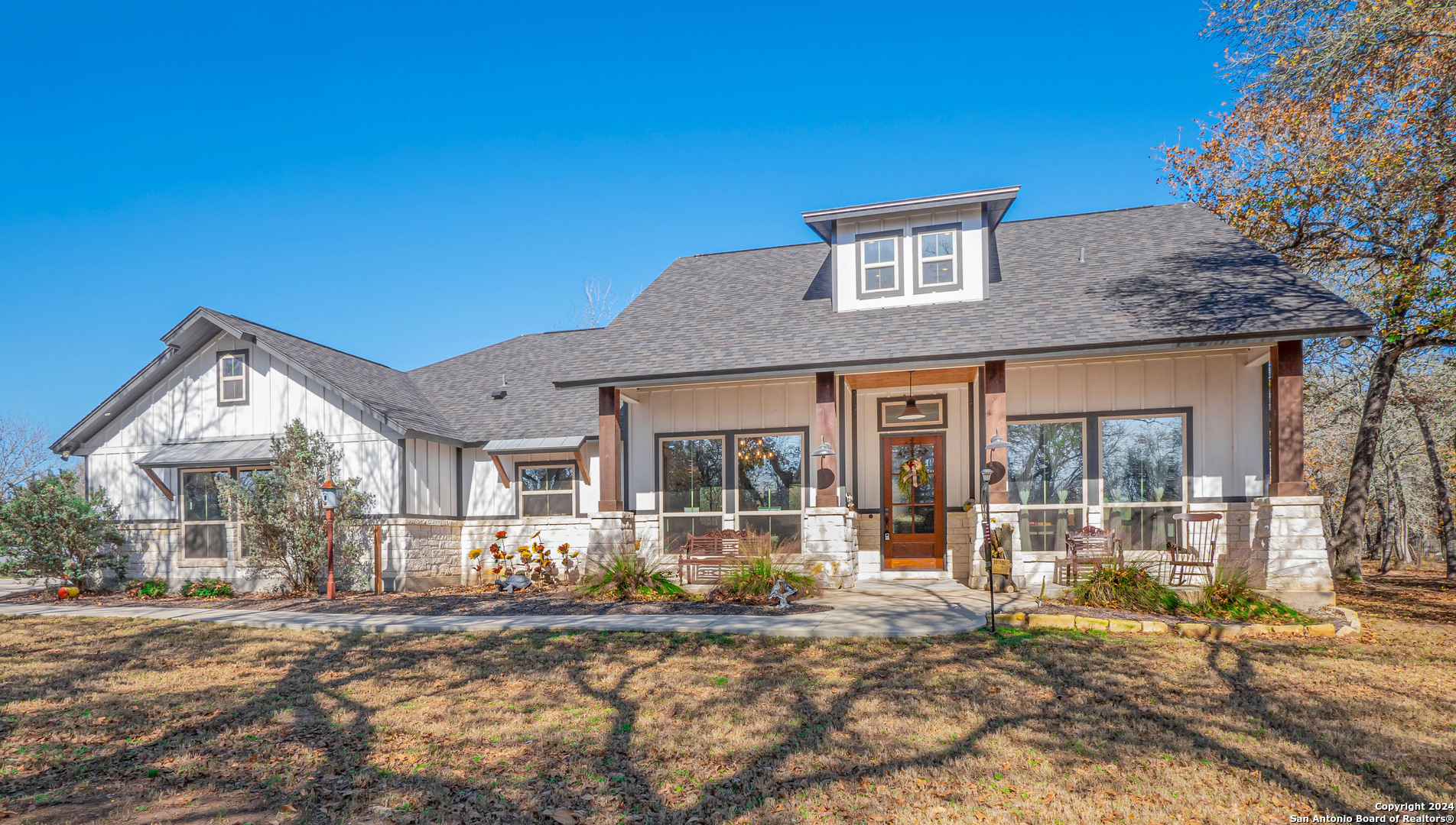 a front view of a house with a yard outdoor seating and outer view