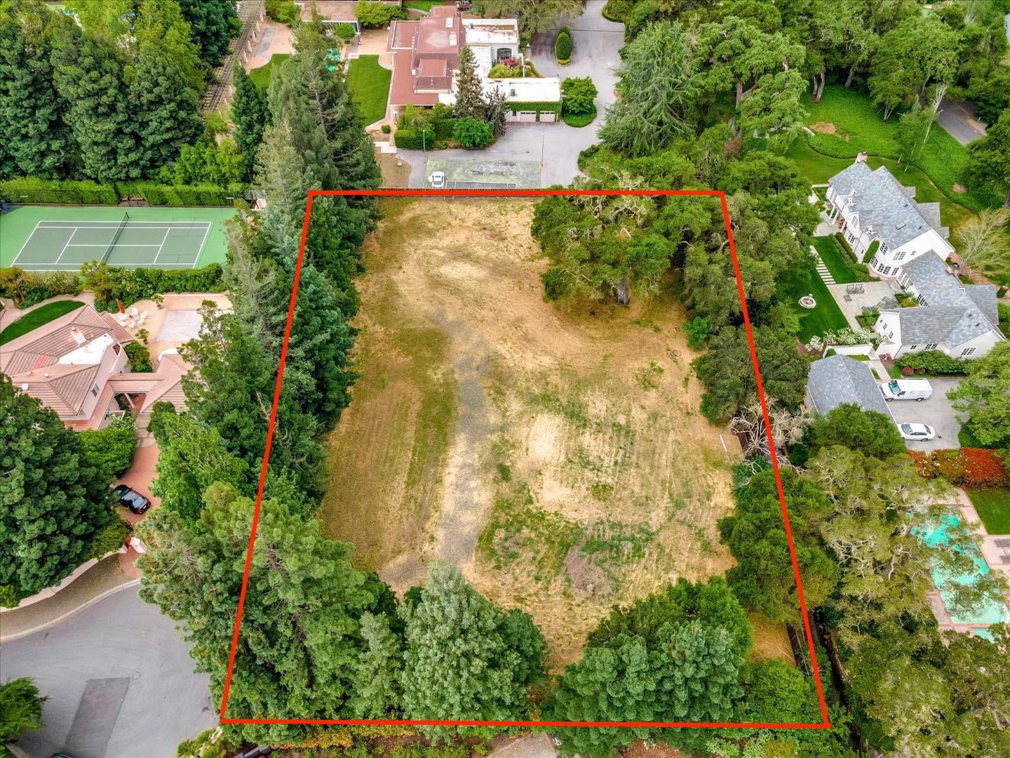 an aerial view of a house with a yard and garden