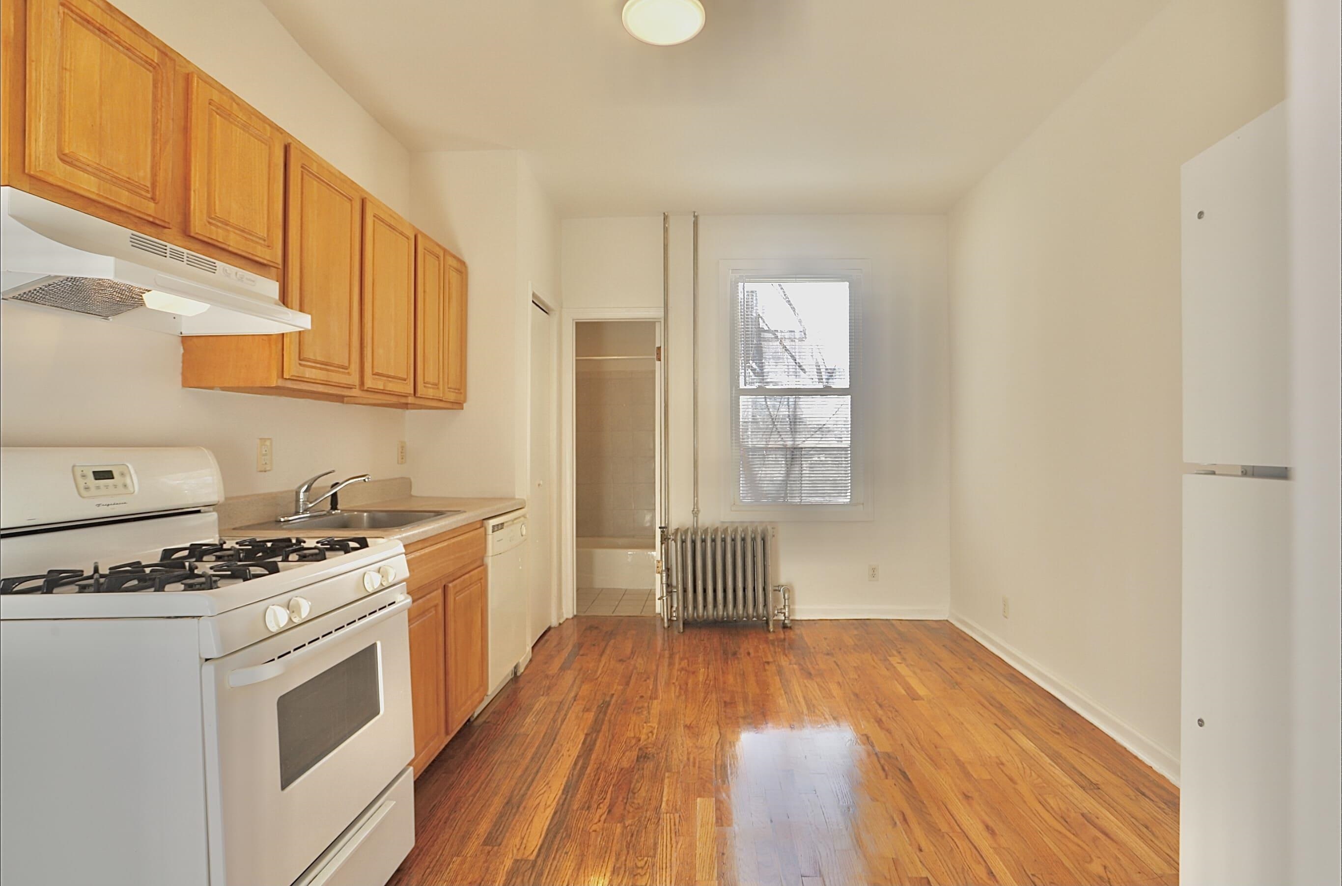 a kitchen with a stove a sink and a refrigerator