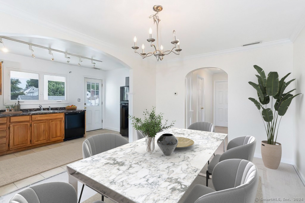 a living room with furniture a chandelier and a dining room