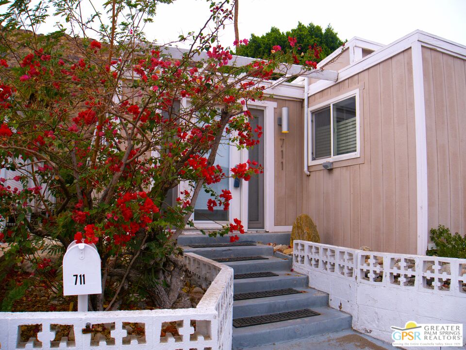 a view of house with outdoor space and sitting area