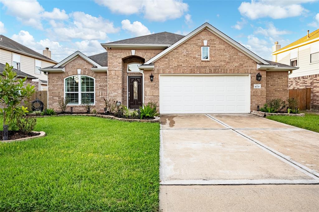 a front view of a house with a yard and garage