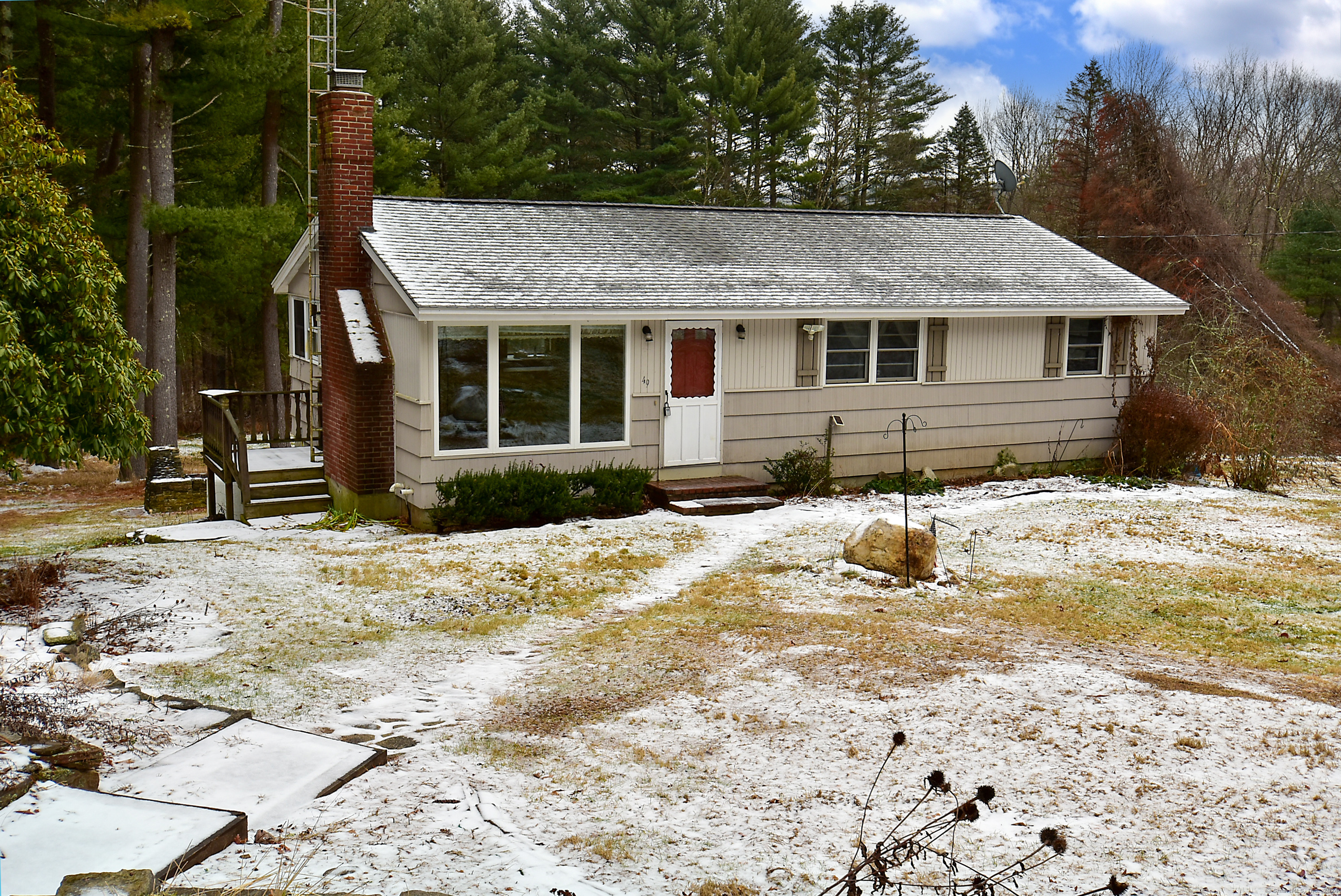 a view of a house with a yard covered in snow