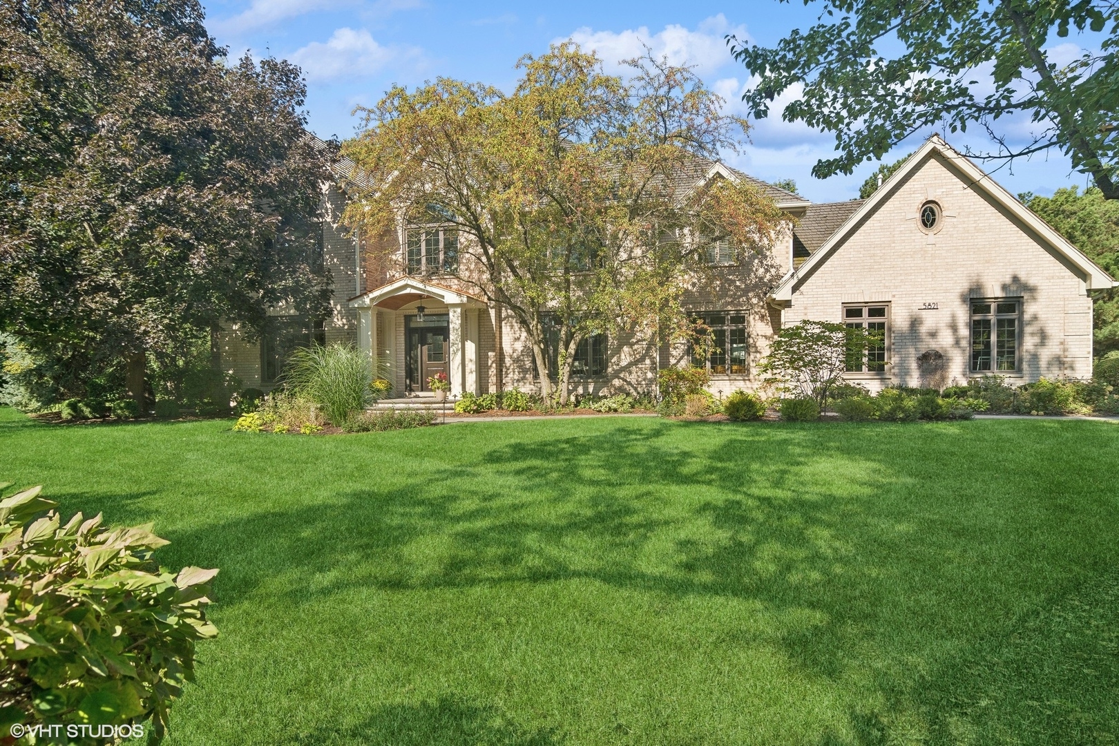 a front view of house with yard and green space