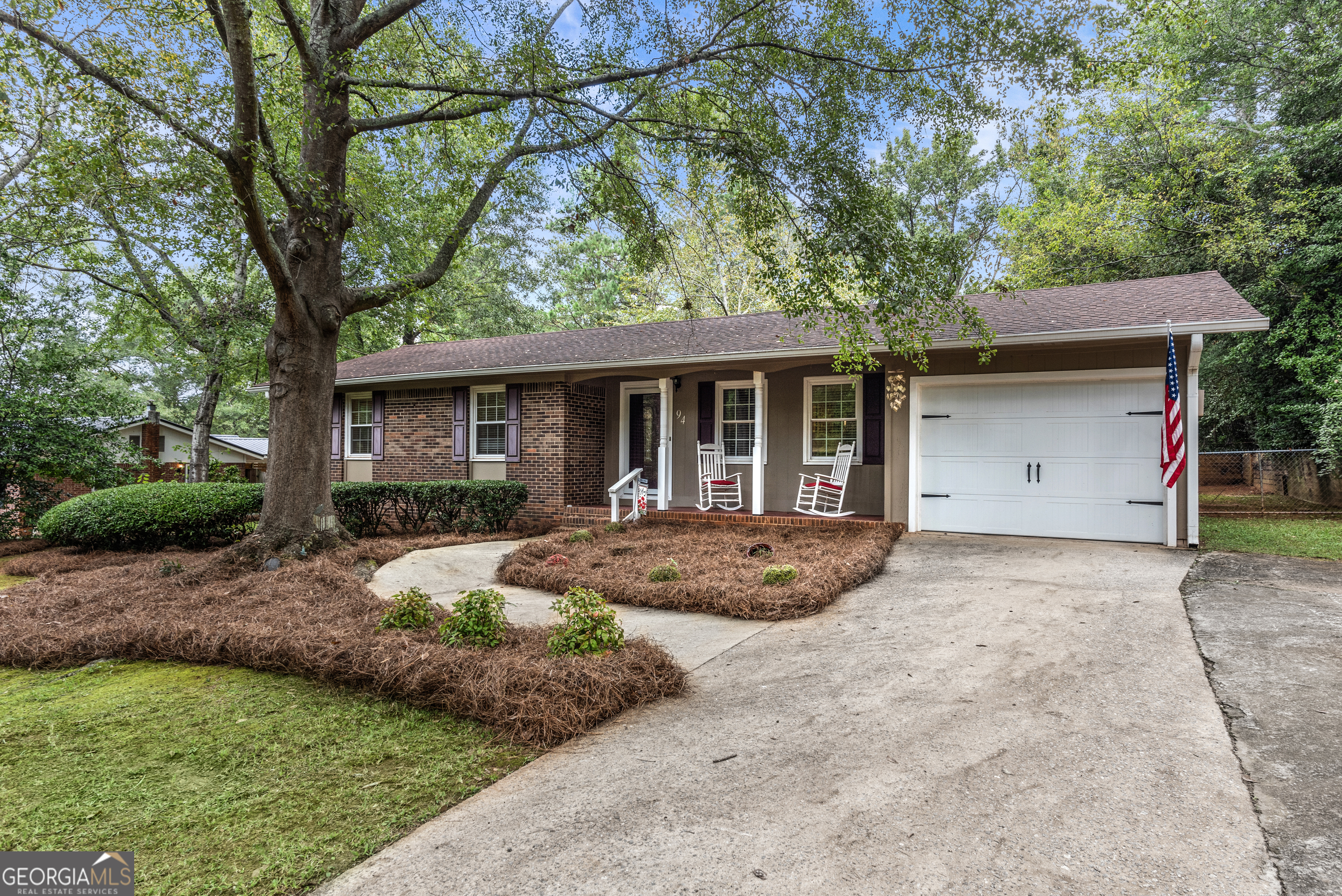 a front view of a house with garden and porch