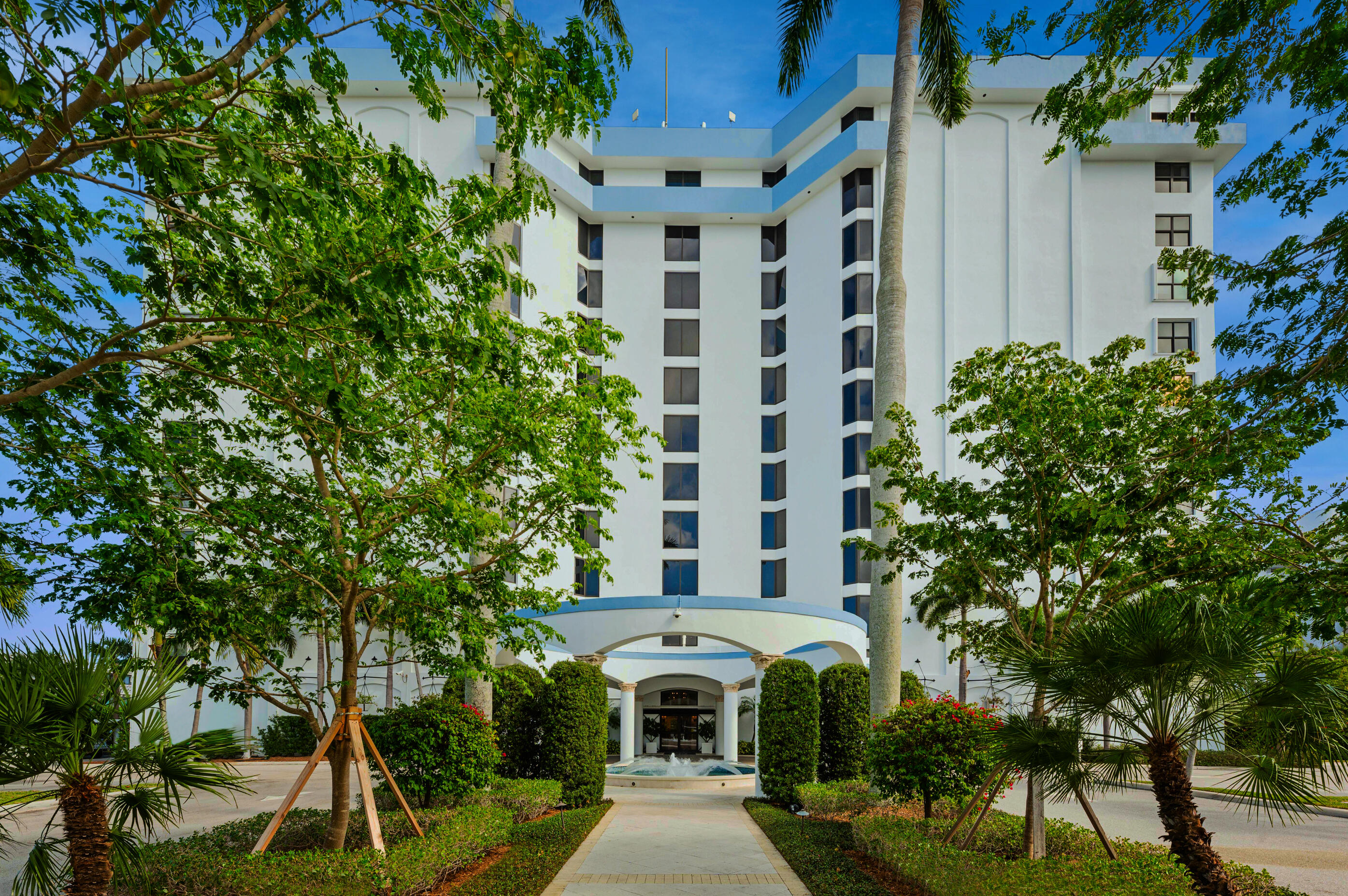 a view of a large building with a tree in front