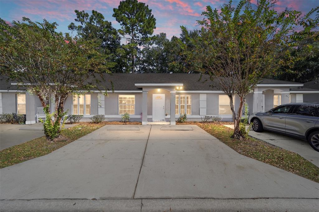 a house view with a sitting space and garden