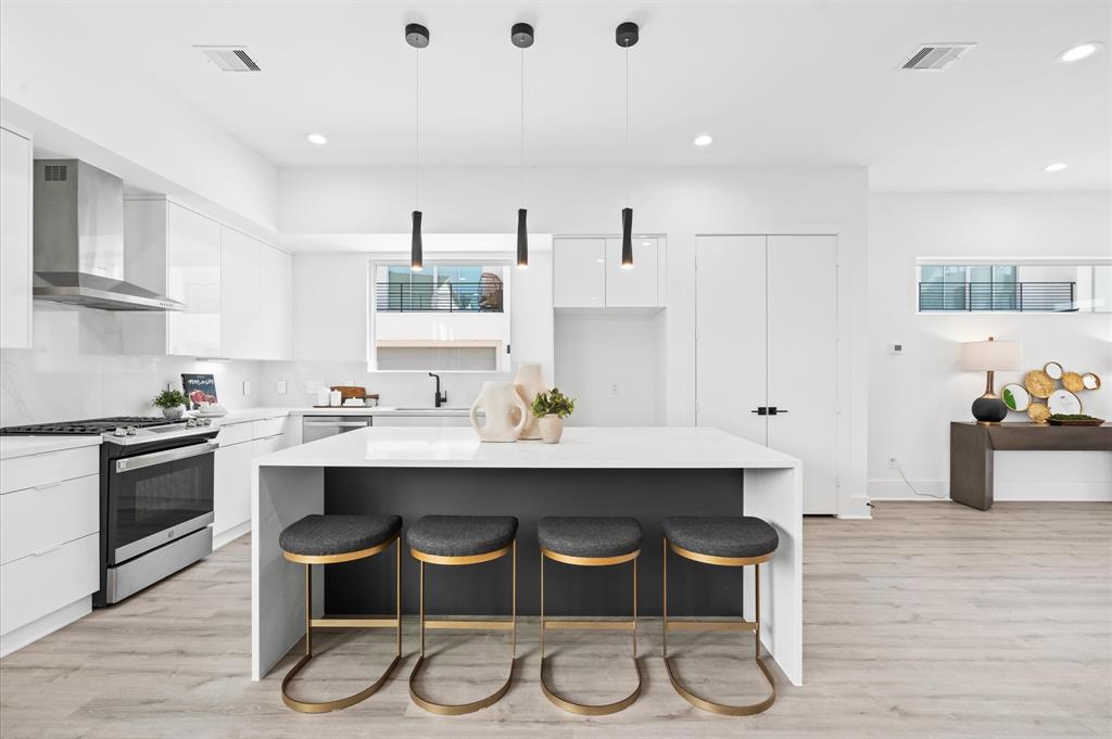 a kitchen with a sink and chairs