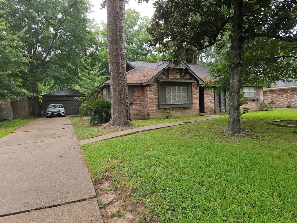 a front view of a house with a yard and trees