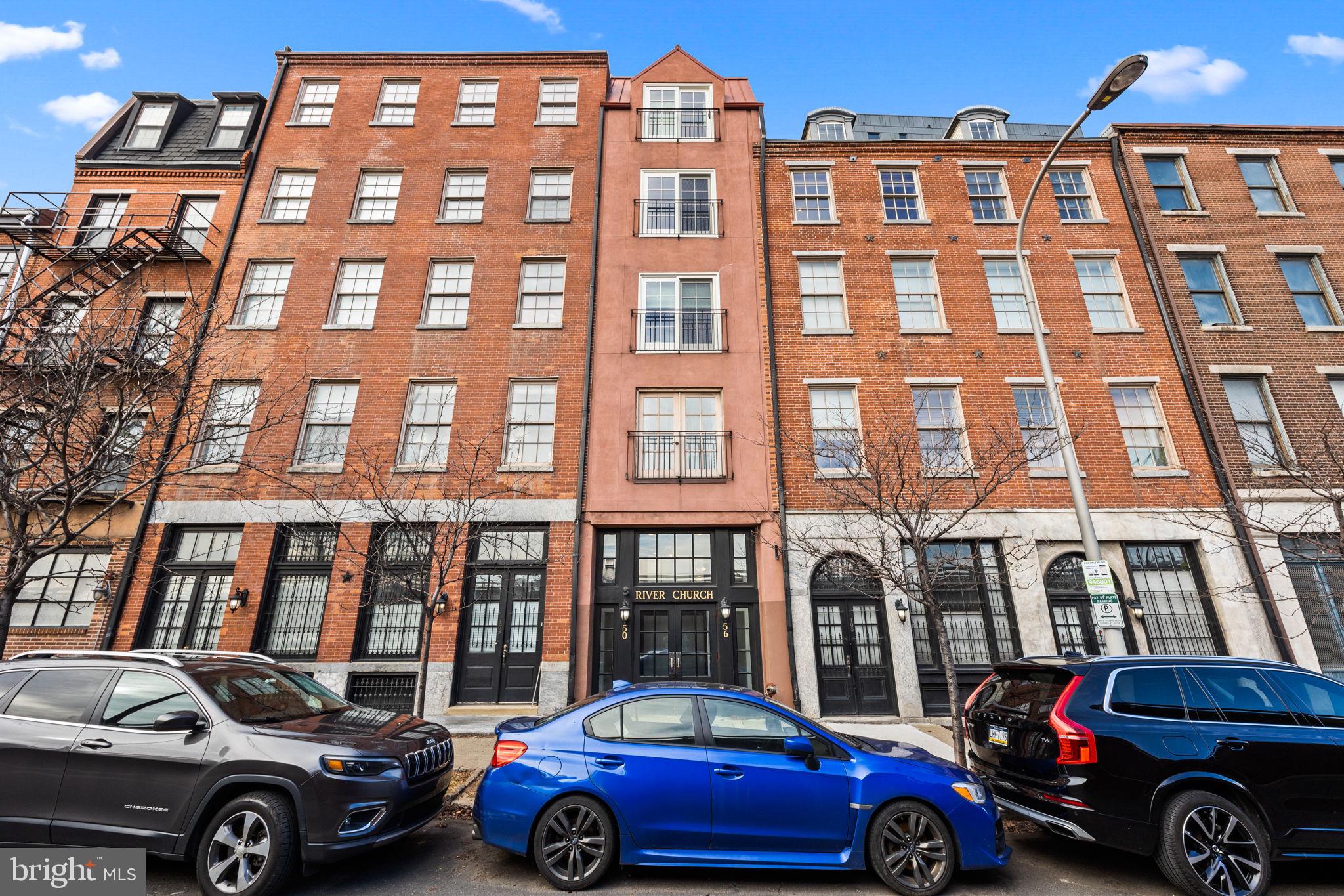 a front view of a residential apartment building with a parking space