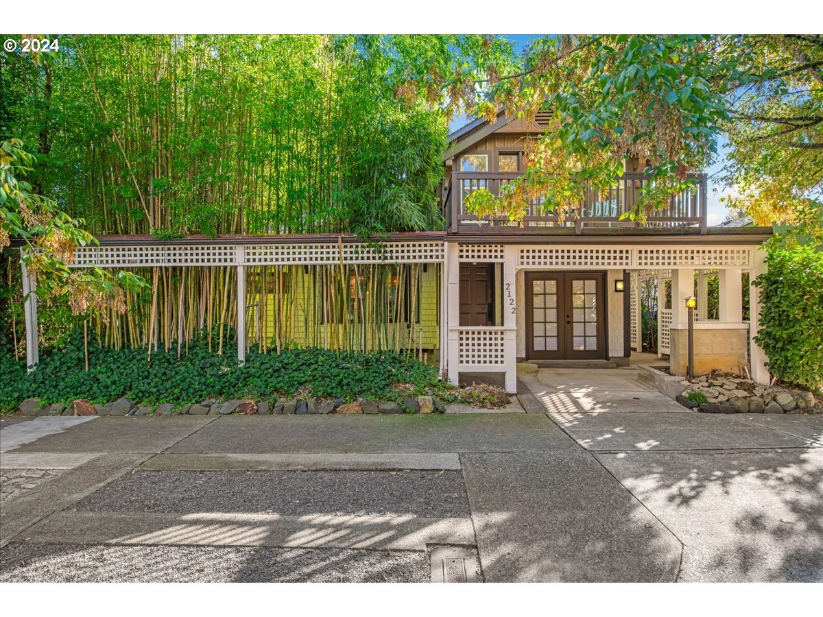 a front view of a house with a garden and patio