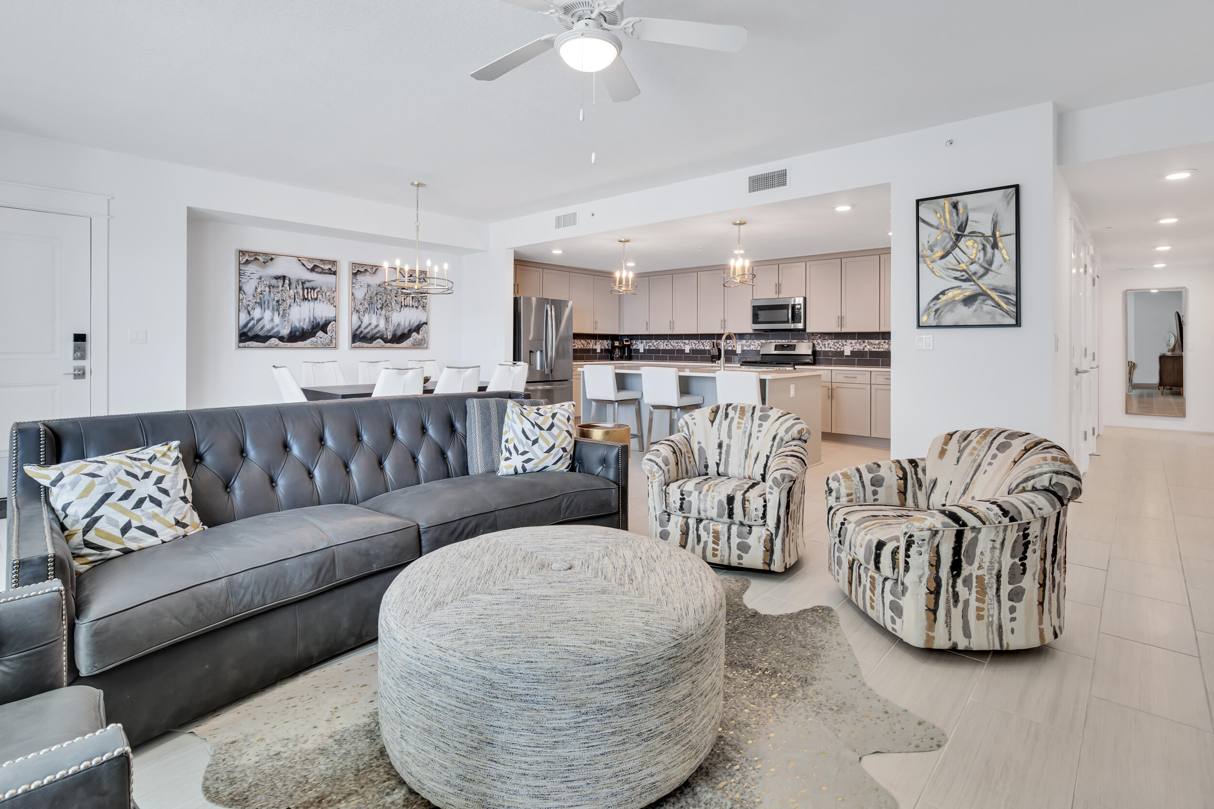 a living room with furniture and kitchen view