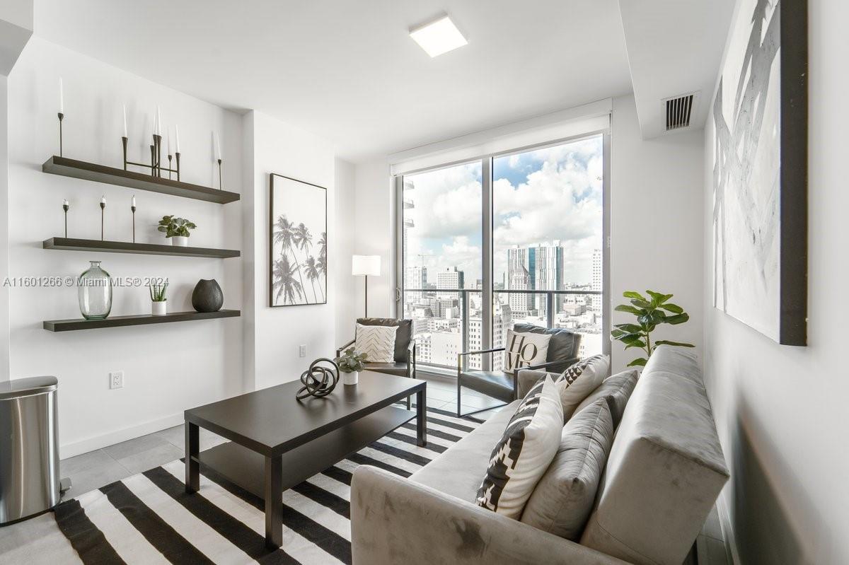 a living room with furniture and a large window