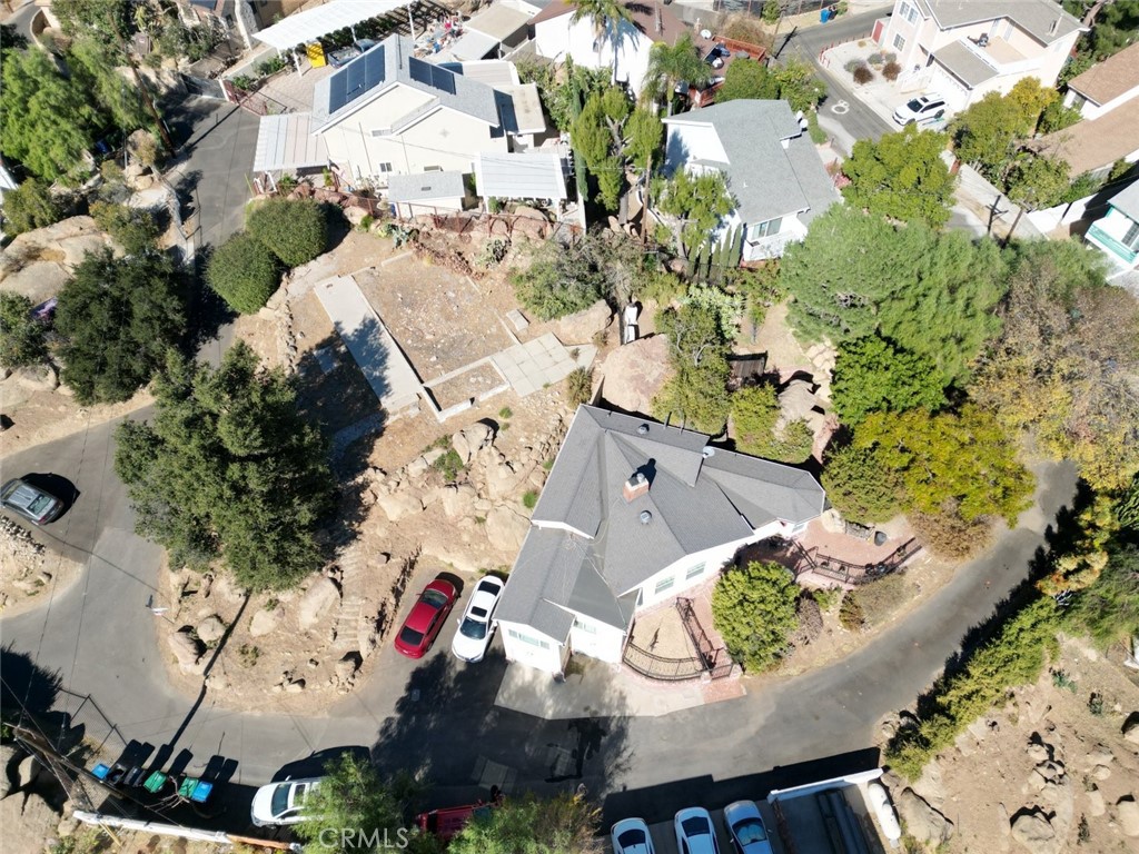 an aerial view of a house with a swimming pool and outdoor seating