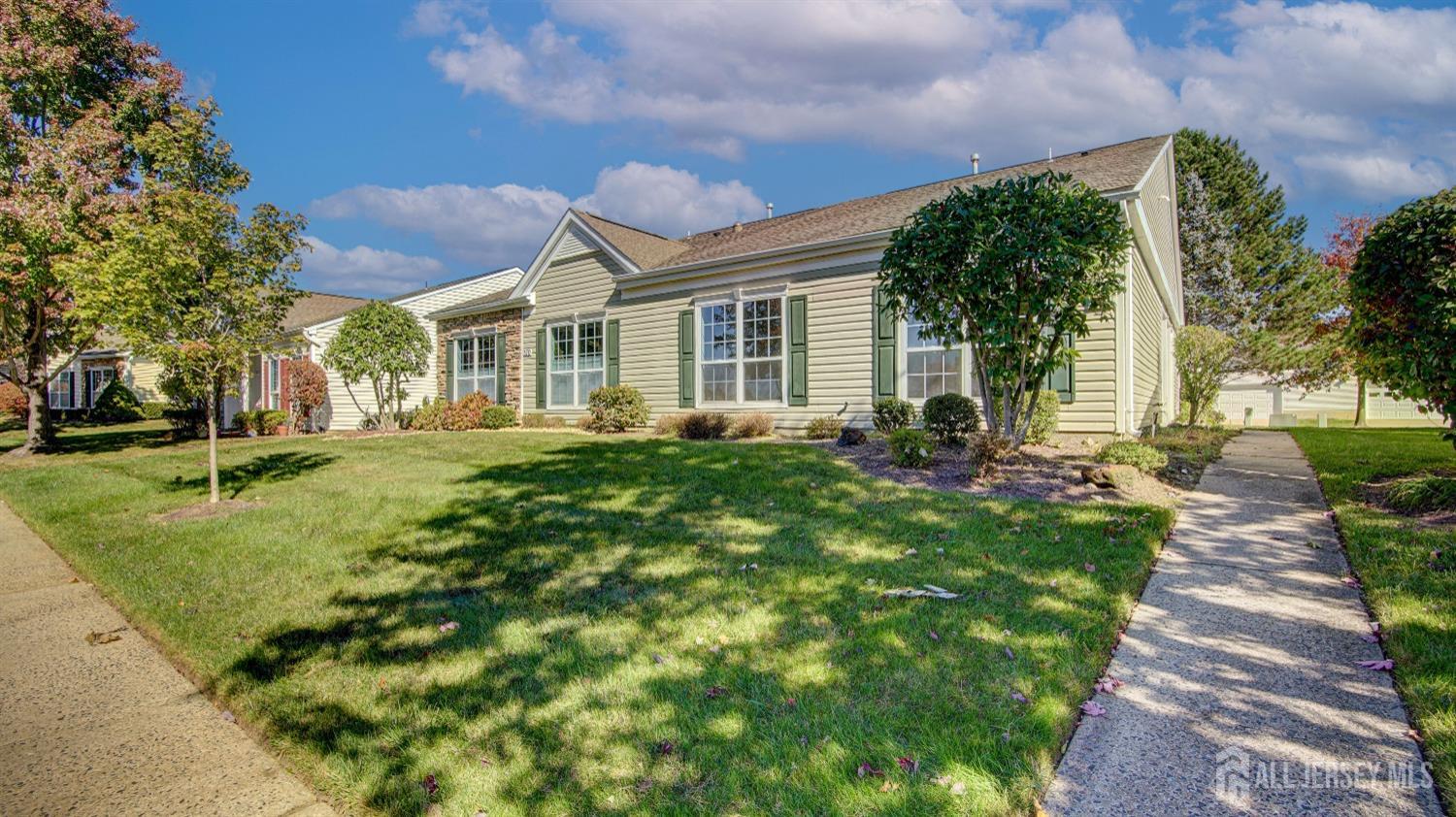 a front view of a house with a garden