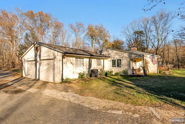 a view of a house with a yard and trees