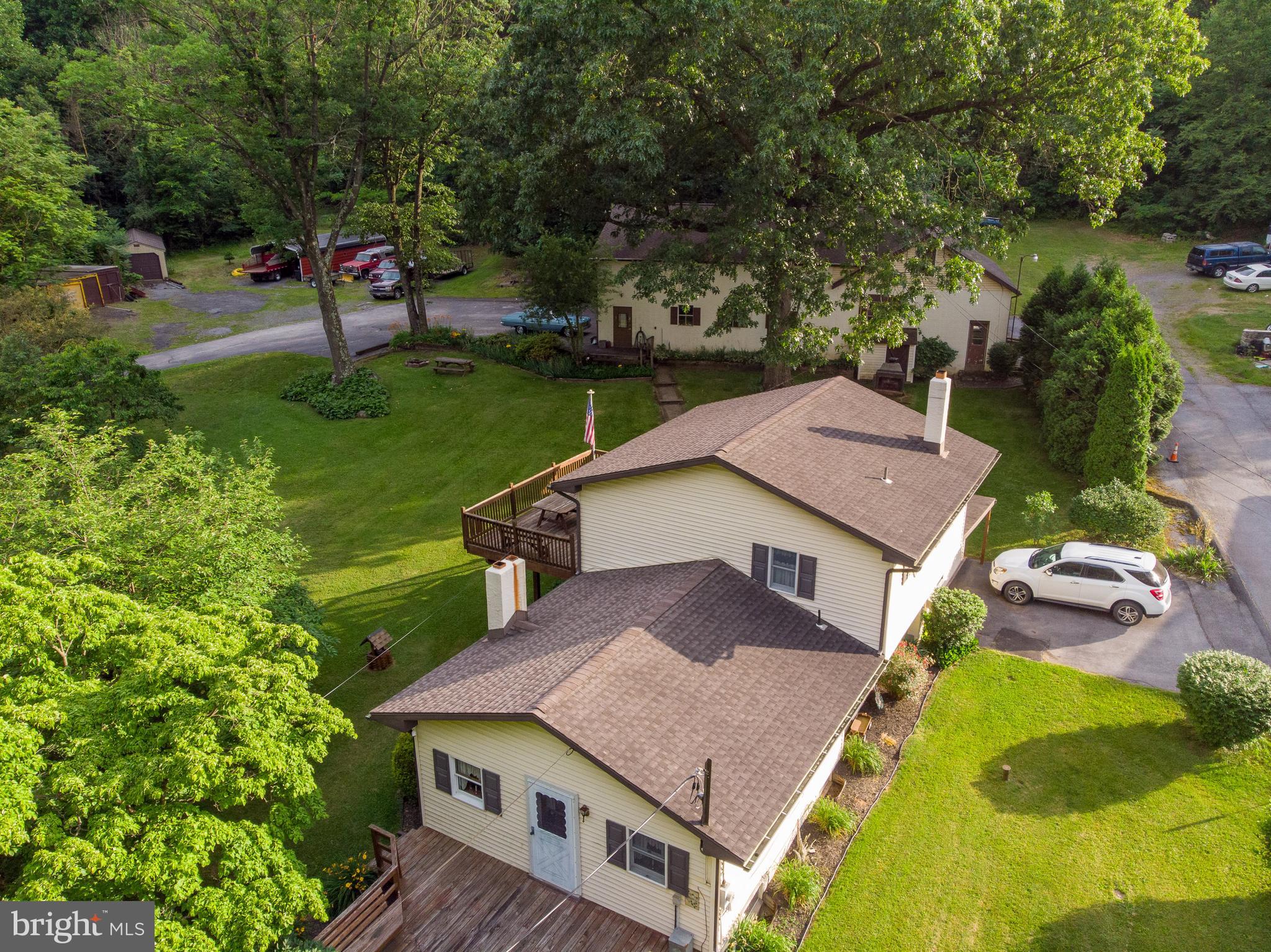 an aerial view of a house with swimming pool and garden