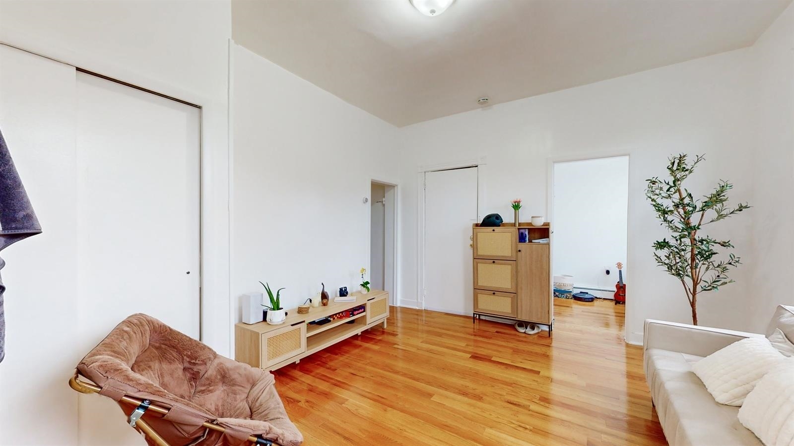 a living room with furniture and wooden floor