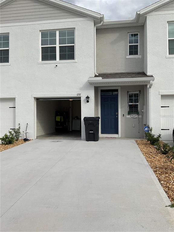 a view of a house with a yard and garage