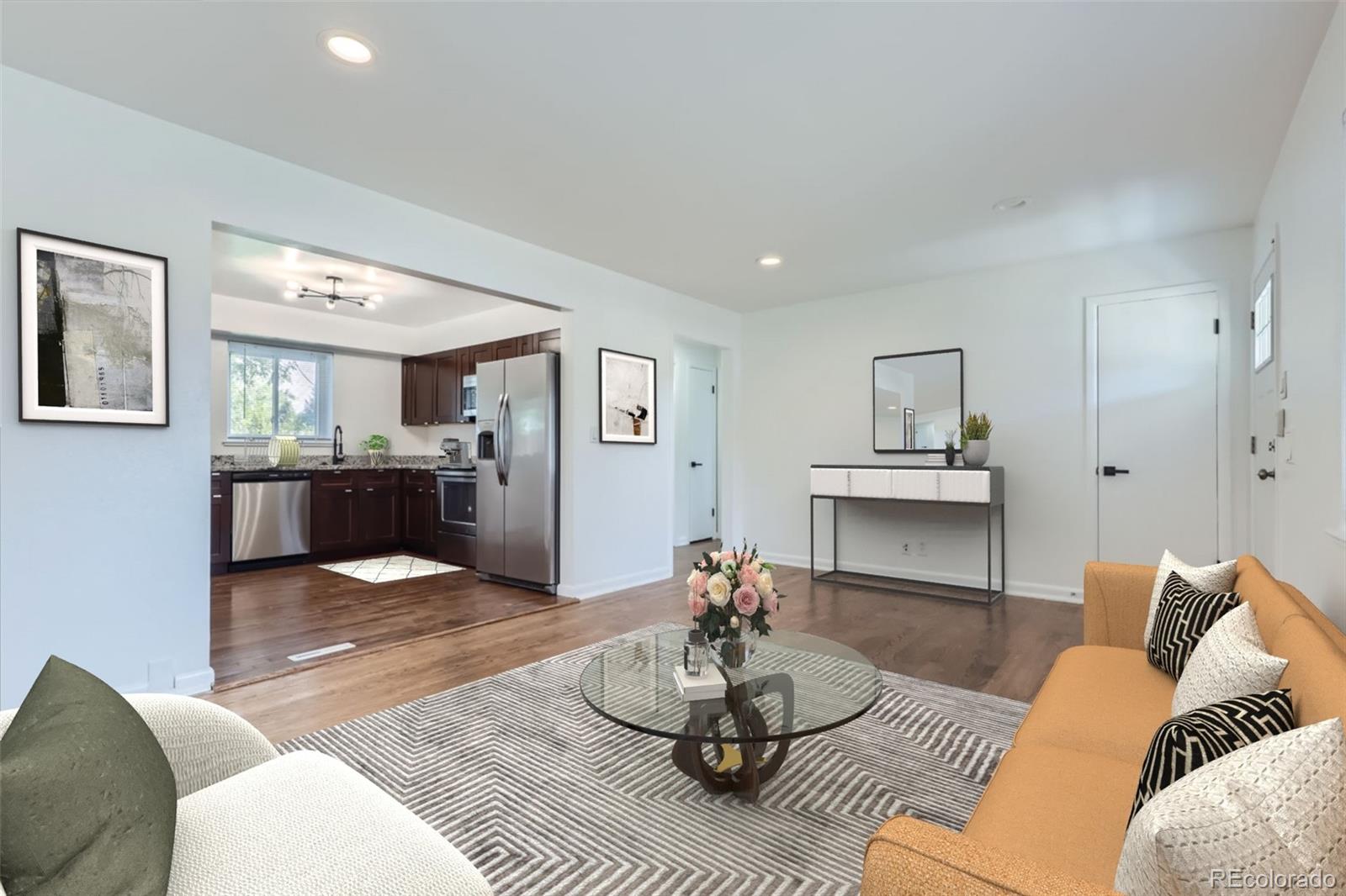 a living room with furniture and a wooden floor