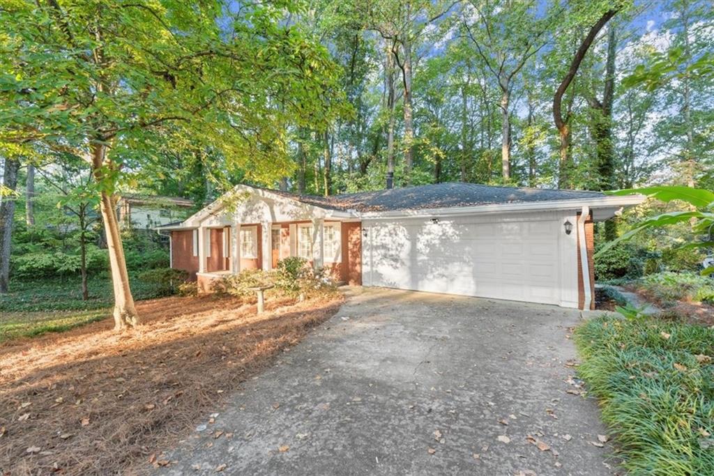 a view of a house with a yard and garage