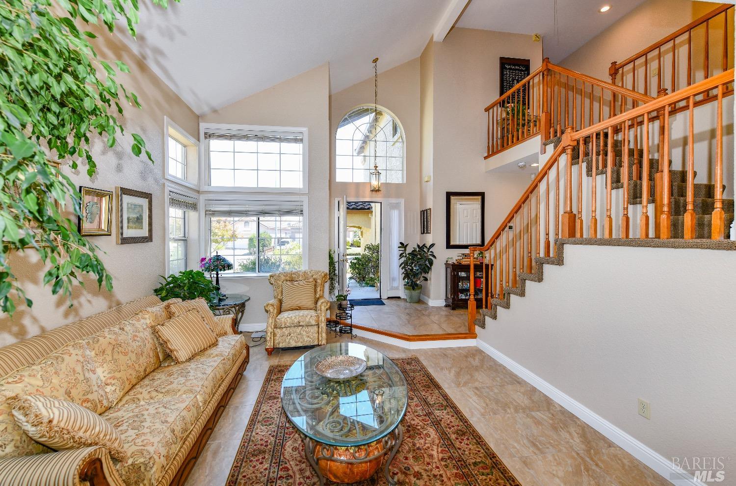 a living room with furniture fireplace and a potted plant