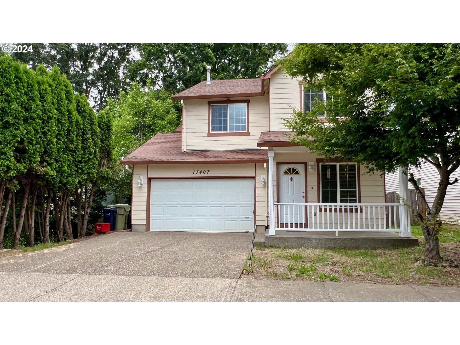 a front view of a house with a garden and yard