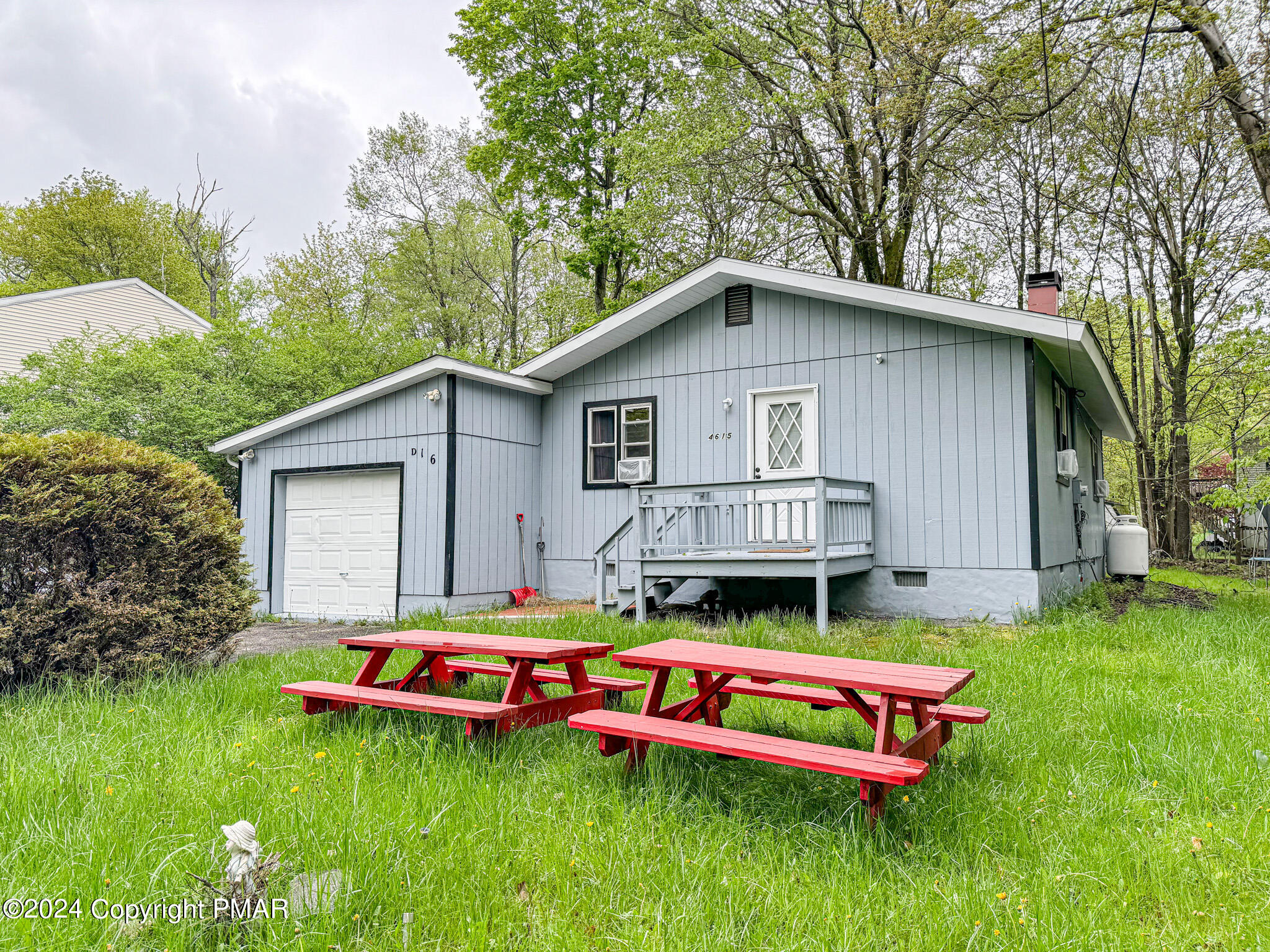 a backyard of a house with table and chairs