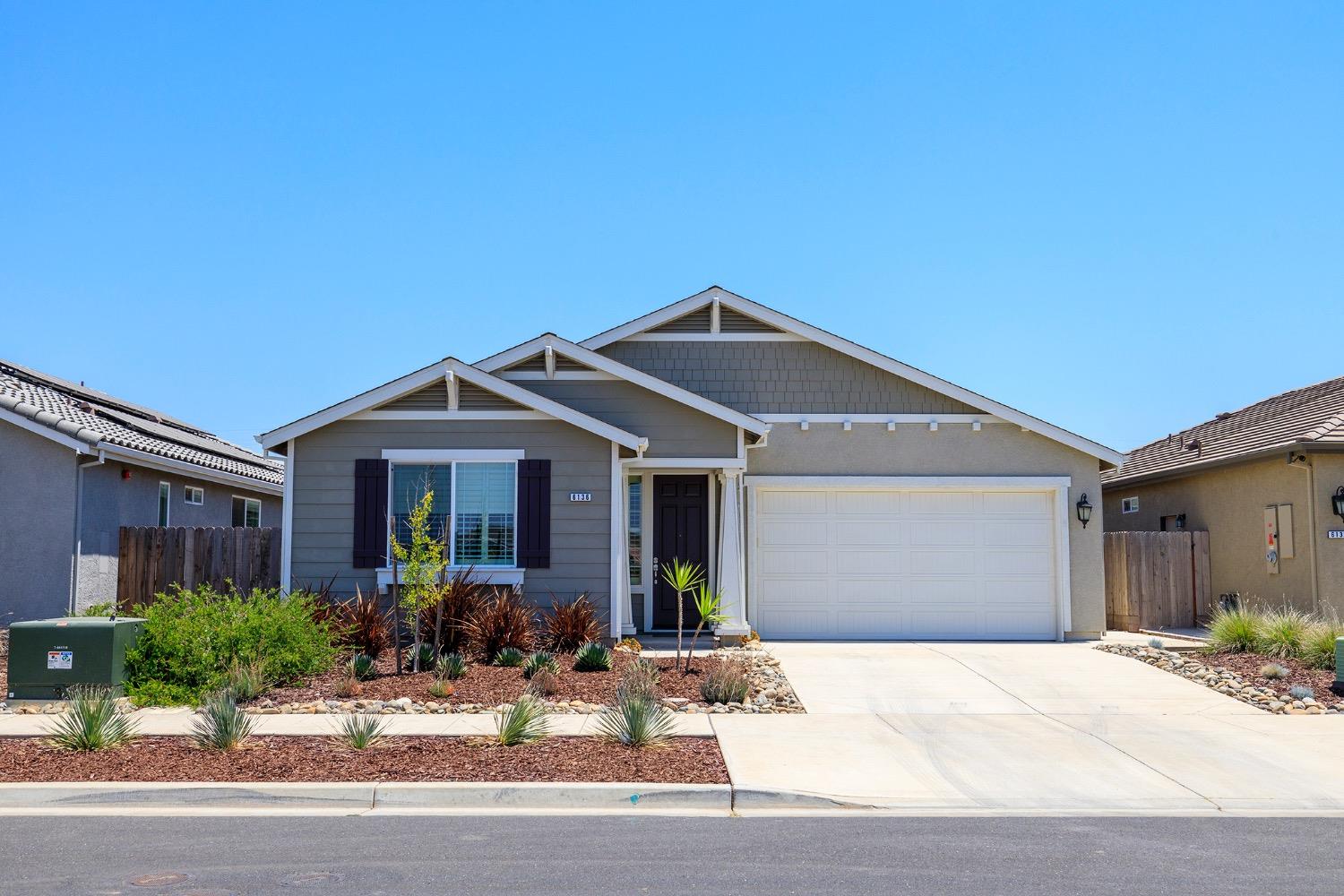 a front view of a house with yard