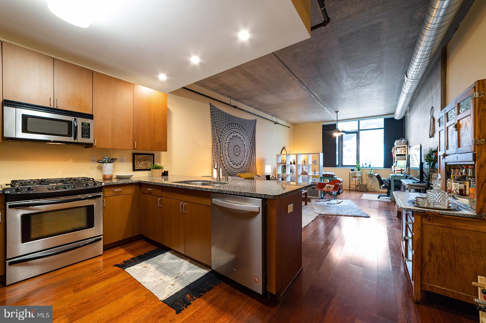 a kitchen with sink stove and cabinets