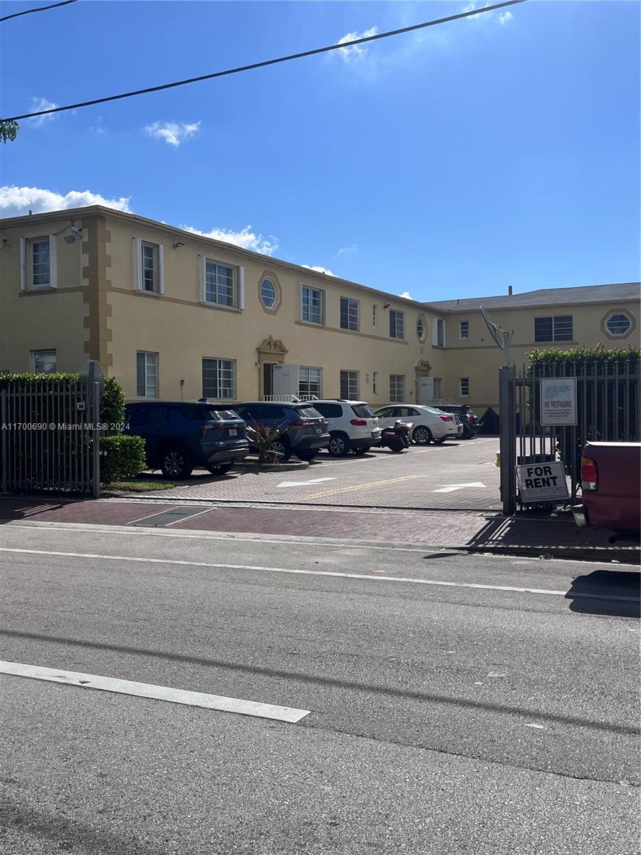 a view of building with car parked