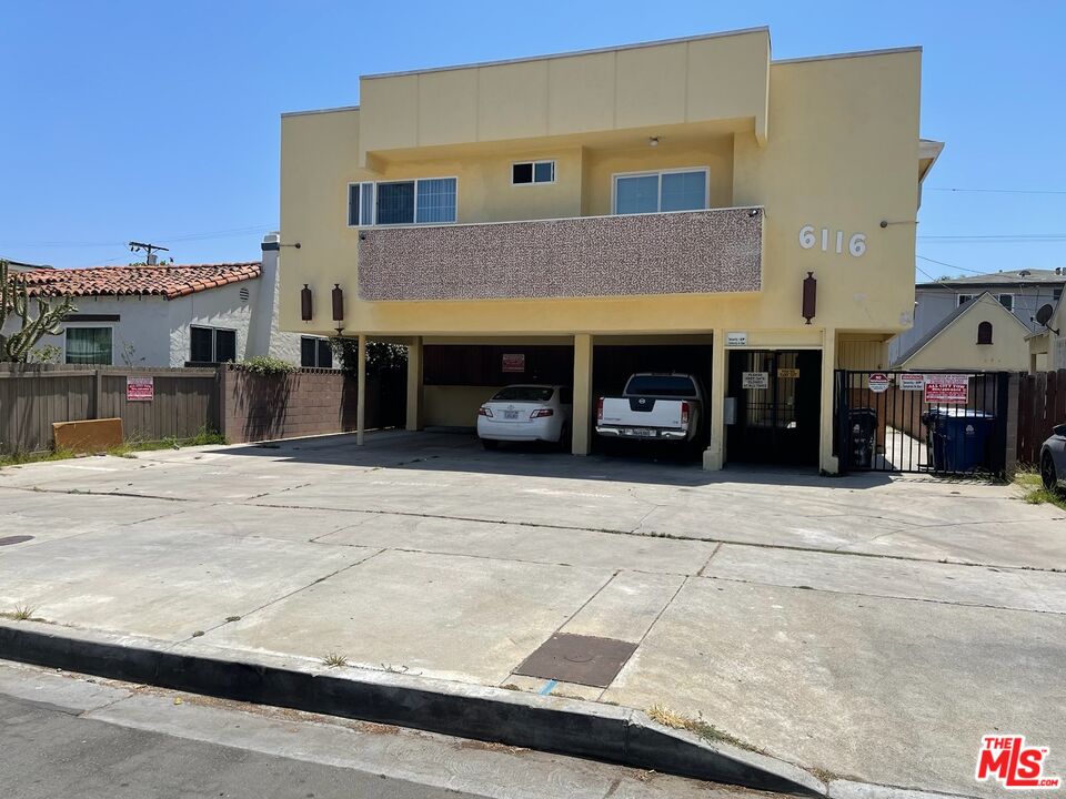 a front view of a house with a road