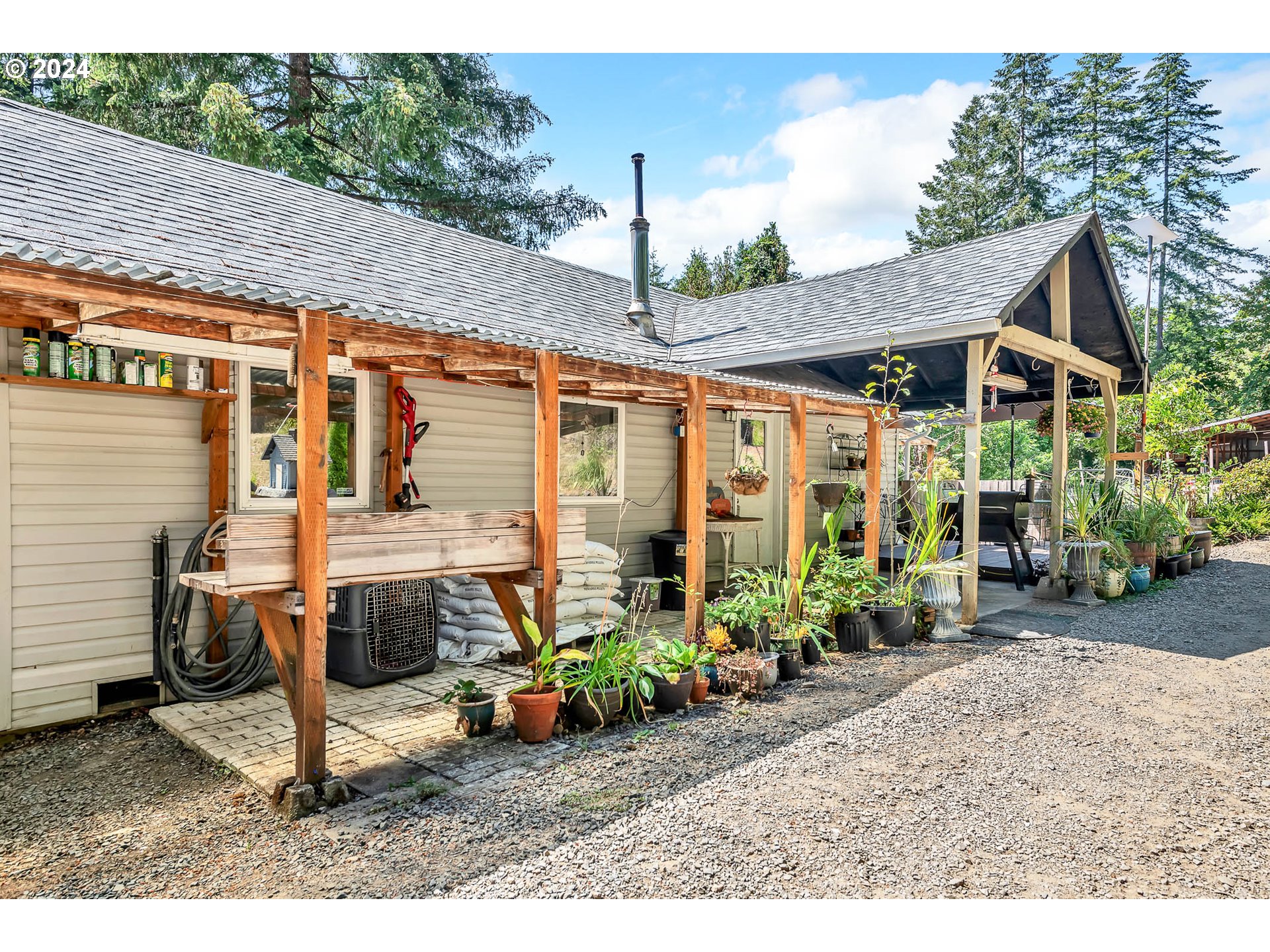 a view of a house with backyard sitting area and garden