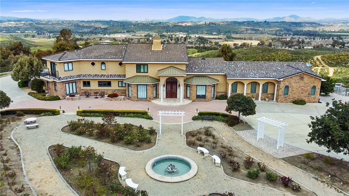 an aerial view of residential houses with outdoor space and parking