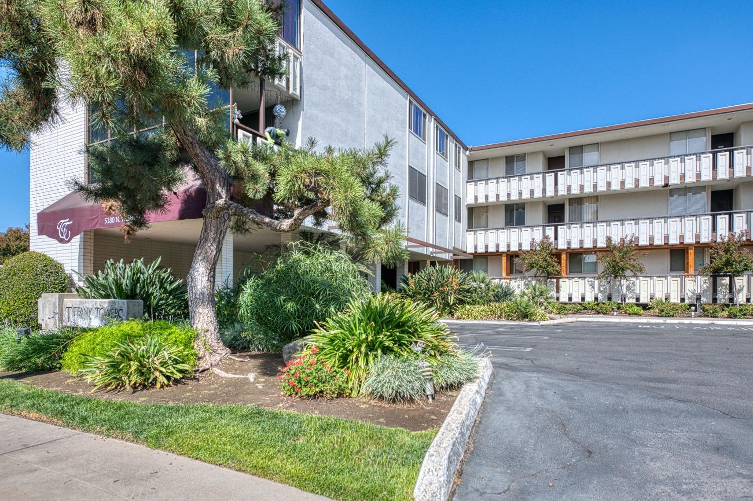 a view of a tall building in the middle of a yard