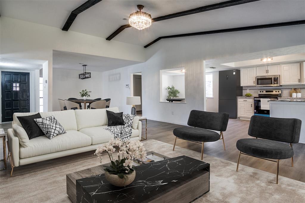 a living room with furniture or chandelier and a wooden floor