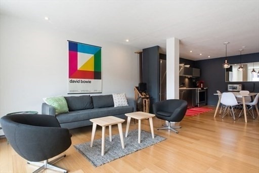 a living room with furniture and kitchen view