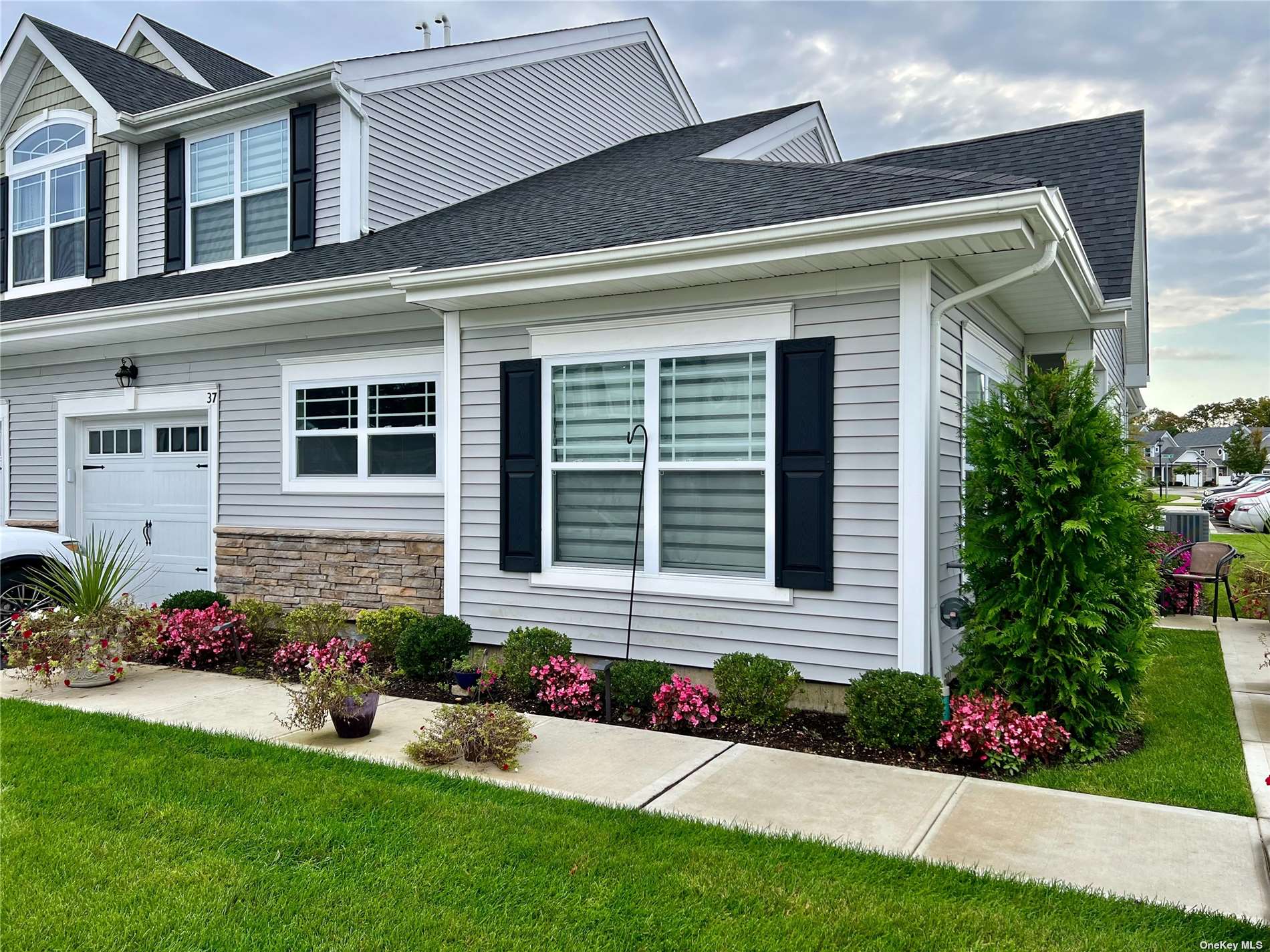 a front view of a house with a yard and outdoor seating