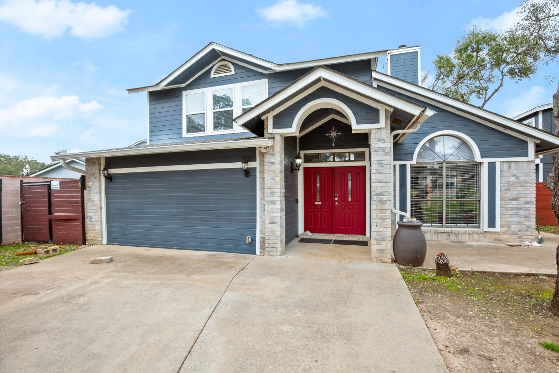 a front view of a house with garage and parking space