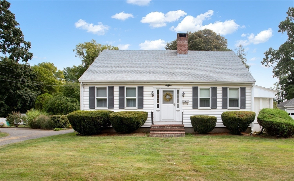 a front view of a house with a garden and plants