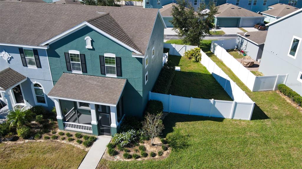 a aerial view of a house with a yard and potted plants