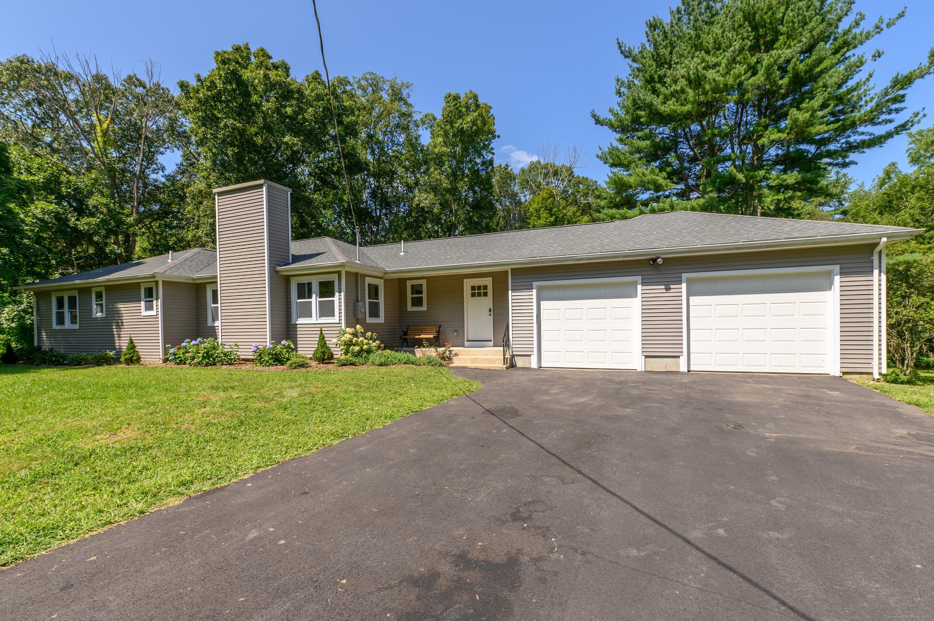 front view of a house with a yard and a garage