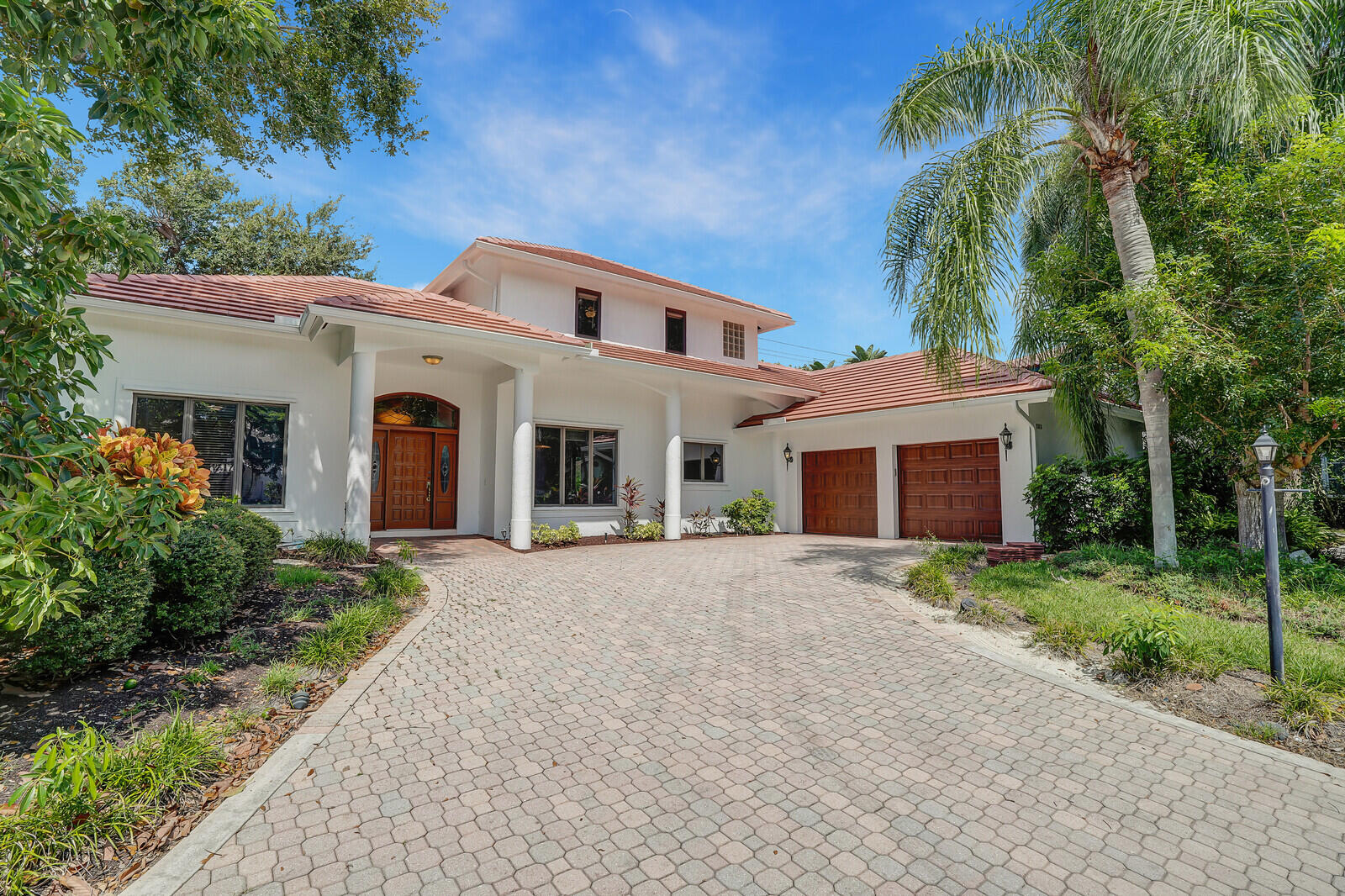 a front view of a house with yard and trees