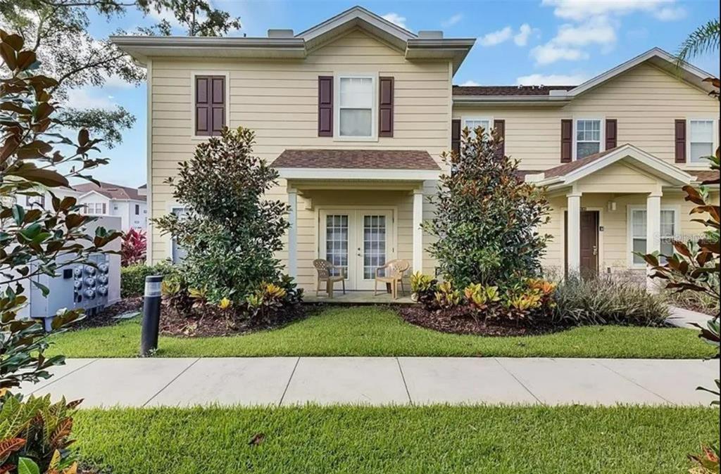 a front view of a house with a garden