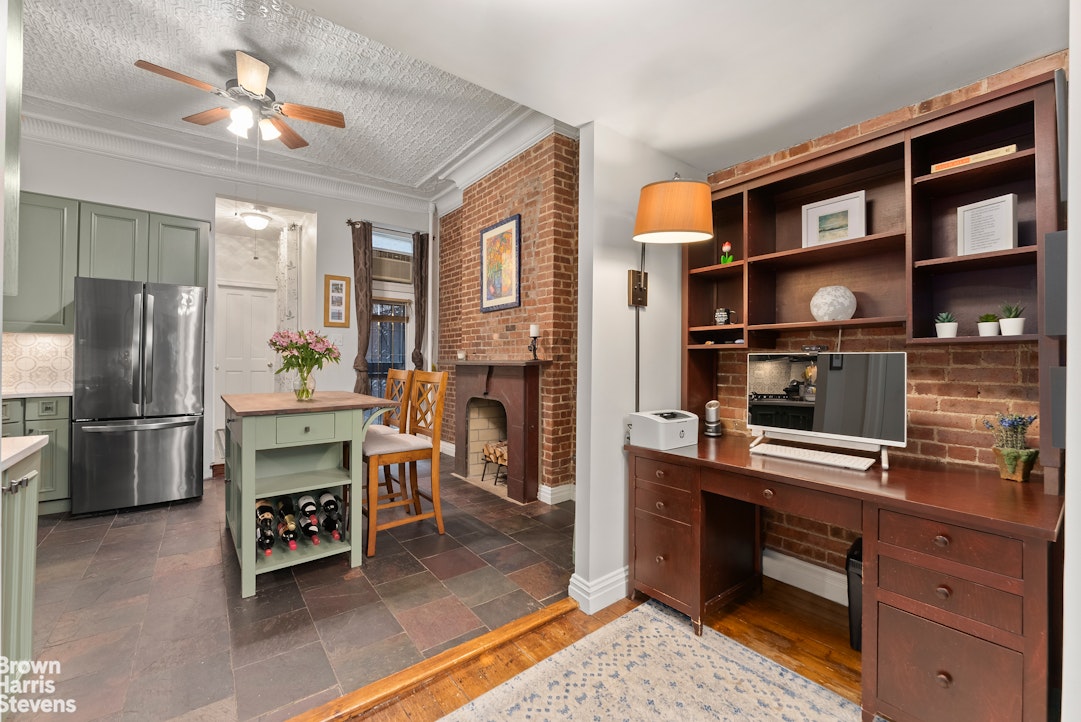 a kitchen with a refrigerator and a stove top oven