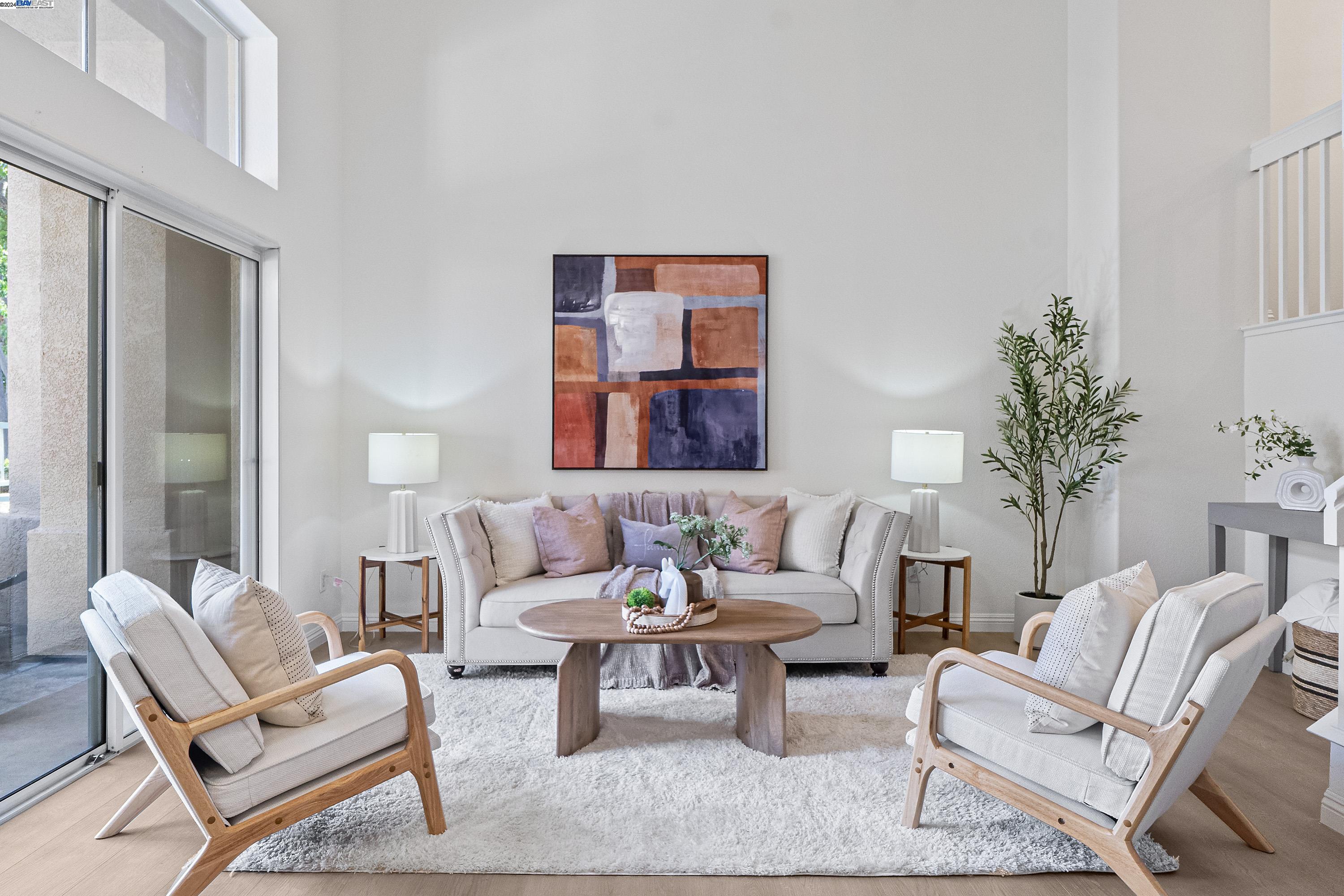 a living room with furniture and a potted plant