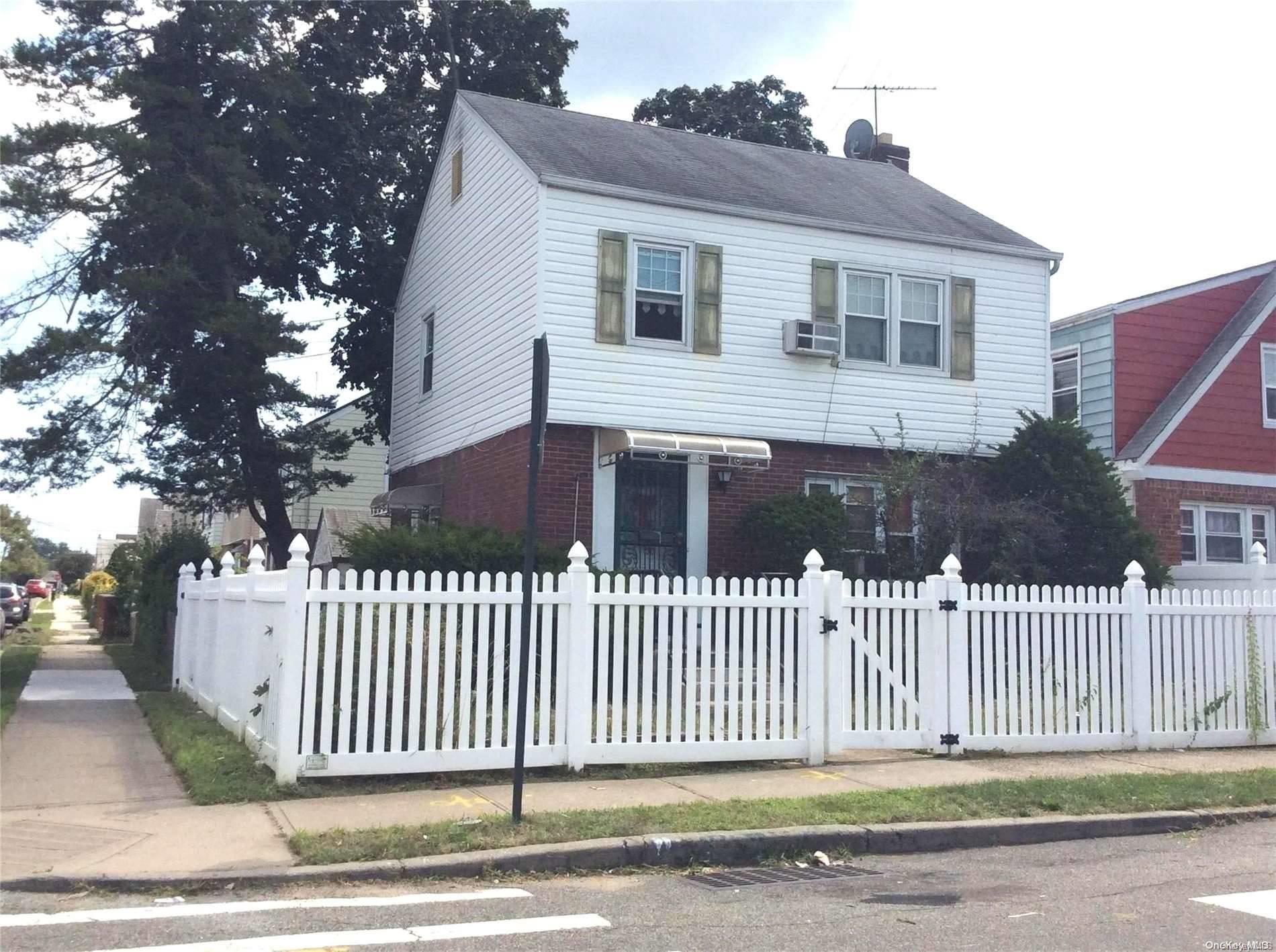 a front view of a house with a fence