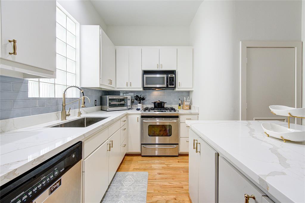 a kitchen with a sink stove and microwave