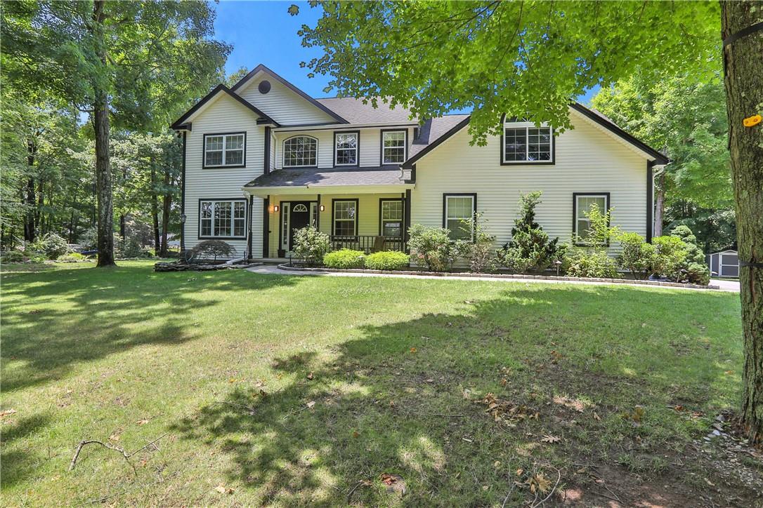 a front view of house with yard and green space