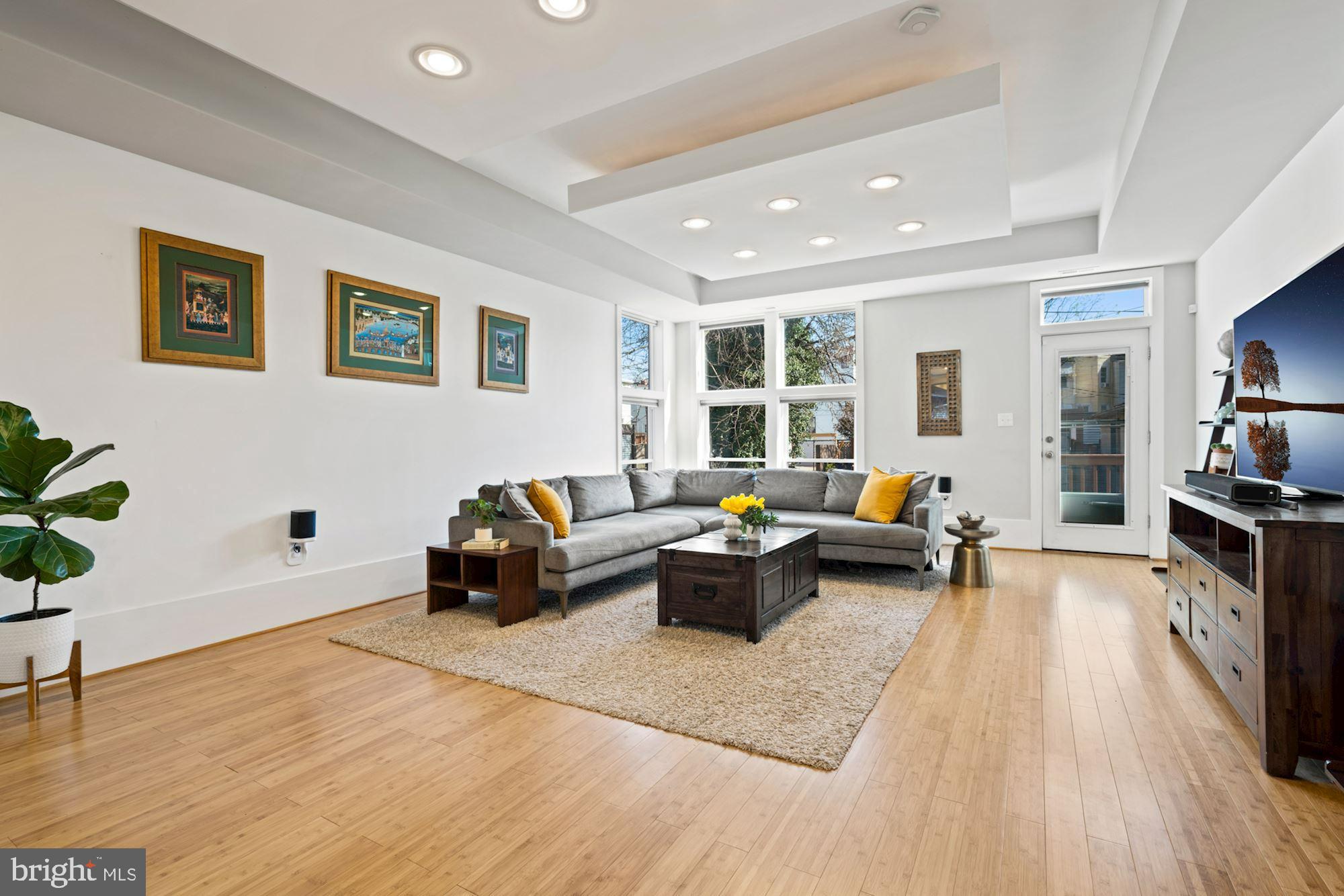 a living room with furniture window and wooden floor